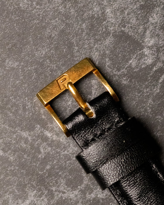 Original Piaget 18K yellow gold buckle fitted to black leather strap, top view