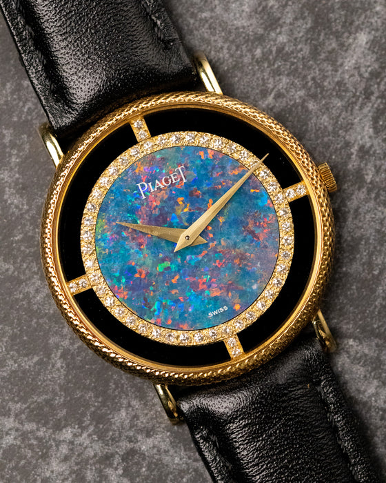 Final hero shot of Piaget Ref. 9026 opal dial watch with factory diamonds, onyx ring, and original gold buckle