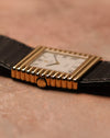 Low side-profile photograph of a Rolex Cellini Ref. 4015 highlighting the stepped ribbed gold case, gold crown, and slim dress-watch proportions.