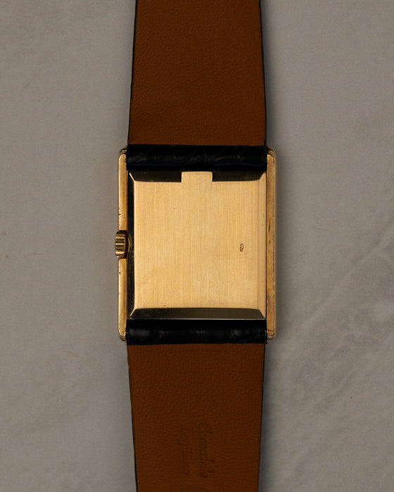 Caseback view of Rolex Cellini 4016 showing polished 18K yellow gold caseback with faint Rolex coronet and serial visible at angles