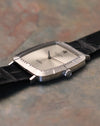 Low-angle side profile of Rolex Cellini 4087 highlighting slim white gold case, brushed bezel texture, and signed crown.