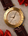 Van Cleef & Arpels Traveller world time watch in 18K yellow gold, featuring engraved city bezel and multi-layer dial with 24-hour ring
