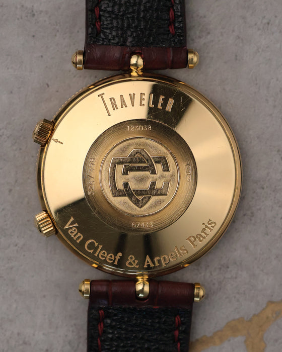 Caseback of Van Cleef & Arpels Traveller showing engraved “Traveller” text, serial numbers, and Van Cleef & Arpels Paris hallmark in 18K gold