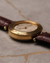 Low-profile perspective of Van Cleef & Arpels Traveller emphasizing case thickness and world time bezel engraving