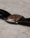 Side profile of Corum Ref. 27119 showing slim white gold case and curved cushion-style shape.