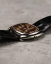 Crown-side profile of Corum white gold case highlighting polished surfaces and thin case construction.