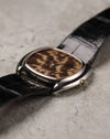 Angled side view of Corum Ref. 27119 emphasizing the smooth case contour and low profile.