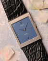 Front view of Rolex Cellini Ref. 4127 in 18K white gold with matte blue dial and Clous de Paris hobnail case, fitted on black leather strap.