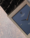 Close-up detail of the Clous de Paris hobnail engraving on the white gold case surrounding the matte blue dial.