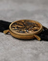 Low side profile of the 18K yellow gold case, emphasising the coin-edge bezel, slim case height, and curved lugs.