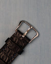 Original 14K white-gold Jaeger-LeCoultre buckle on black leather strap, top view