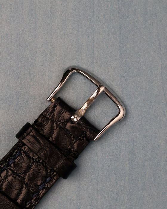 Original 14K white-gold Jaeger-LeCoultre buckle on black leather strap, top view