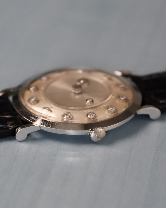 Angled side view showing crown detail and floating diamond indicators beneath the crystal