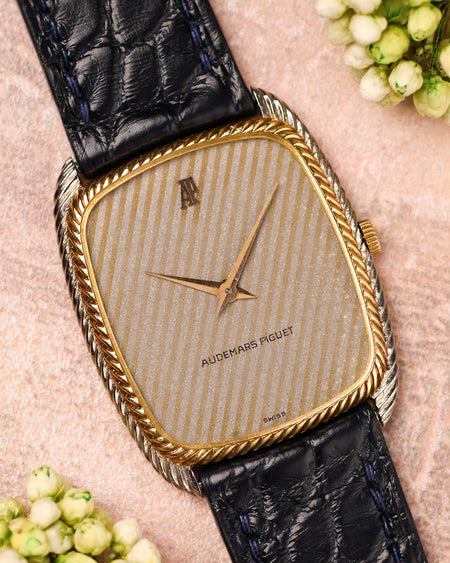 Audemars Piguet ref. 4157 CA tonneau watch with snowflake textured dial and yellow gold rope bezel, front view on leather strap.