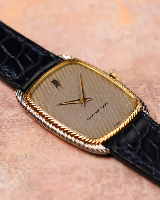 Angled view of Audemars Piguet 4157 CA showing curved tonneau case and two-tone gold construction.