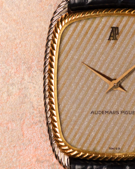 Macro detail of Audemars Piguet 4157 CA bezel showing twisted rope design in yellow gold.