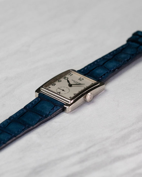 Three-quarter view of Patek Philippe Gondolo 5010 white gold dress watch on blue leather strap