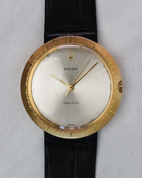 Full frontal view of Rolex Zephyr Ref. 9919 with silver dial, gold hands, and black leather strap