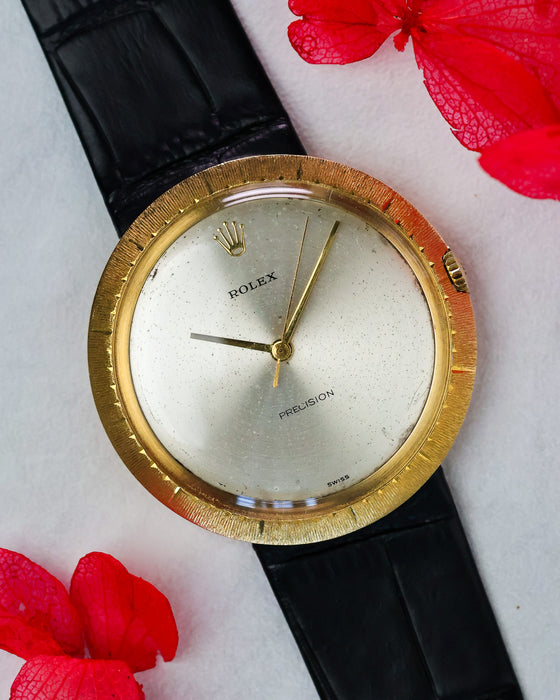 Rolex Zephyr Ref. 9919 front view with silver dial and textured “Disco Volante” bezel, styled with red flowers