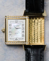 Reverso case partially flipped showing front mother-of-pearl dial alongside guilloché inner case surface.