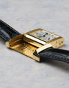 Side profile of the Reverso case showing thickness, polished yellow gold surfaces, and hinge mechanism.
