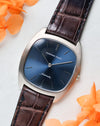Audemars Piguet Ref. 5279 angled view with blue dial and white gold case placed beside orange flowers
