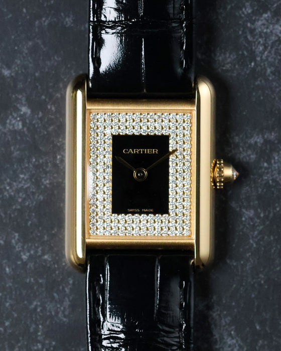 Top-down view highlighting symmetry of diamond-set dial and lacquer centre on yellow gold case.