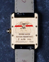 Caseback of Cartier Tank in brushed yellow gold with engraved markings and screws visible.