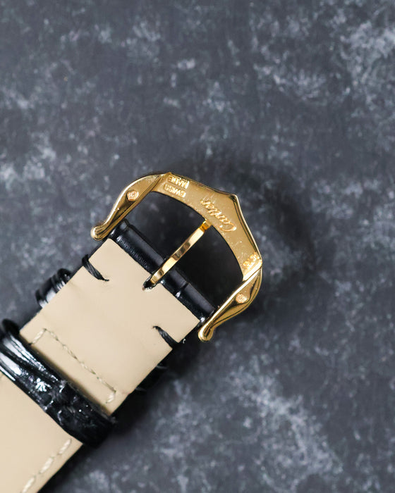 Reverse angle of buckle showing Cartier engravings on gold clasp.