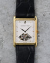 Front view of the Audemars Piguet showing its white dial, applied gold markers and exposed movement aperture at six.