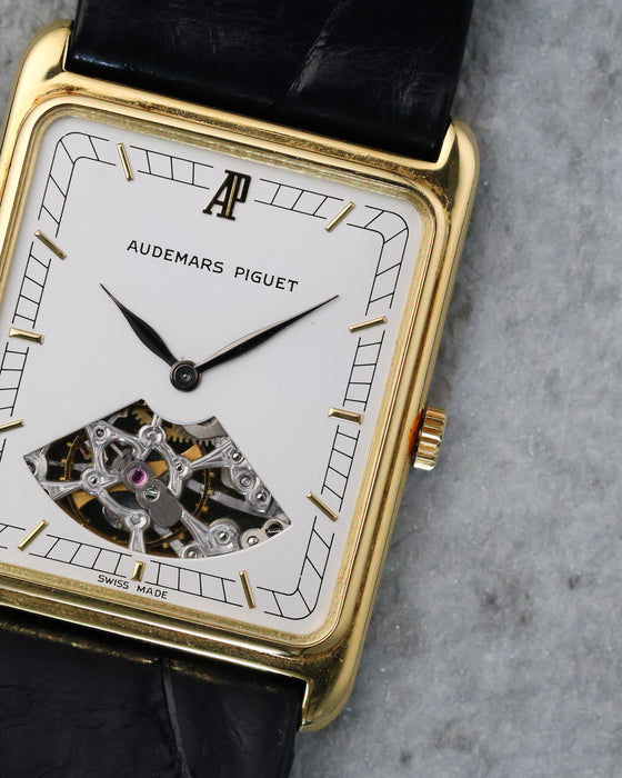 Macro view of the Audemars Piguet dial showing the applied AP logo, geometric minute track and openworked movement.