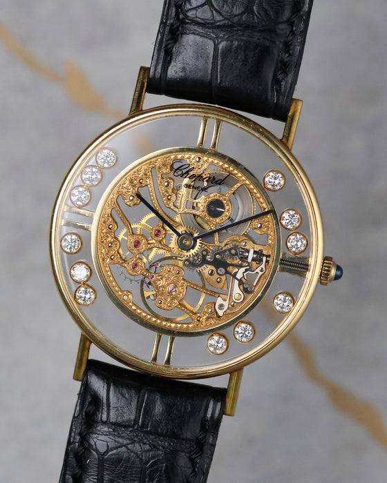 Angled front view of Chopard L.U.C Happy Diamonds skeleton dial with floating diamonds and black strap.