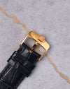 Close-up of Chopard L.U.C Happy Diamonds buckle in 18k yellow gold with engraved logo.