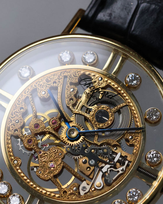 Macro detail of Chopard L.U.C Happy Diamonds skeleton movement with blued hands and engraved bridges.