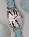 Angled dial view of the Cartier Tonneau WE400731 showing the curved white dial and diamond-set case.