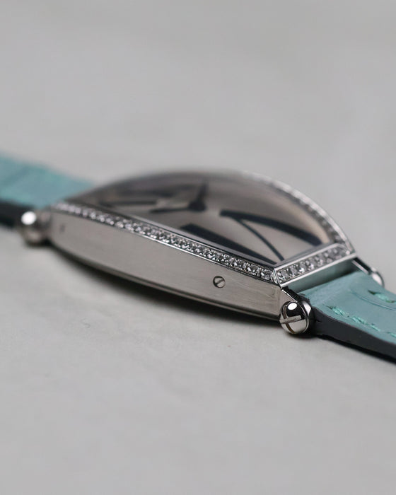 Low angle side view of the Cartier Tonneau WE400731 highlighting the curved case and diamond-set bezel.