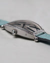 Side angle of the Cartier Tonneau WE400731 with focus on the faceted crown and diamond-set bezel.