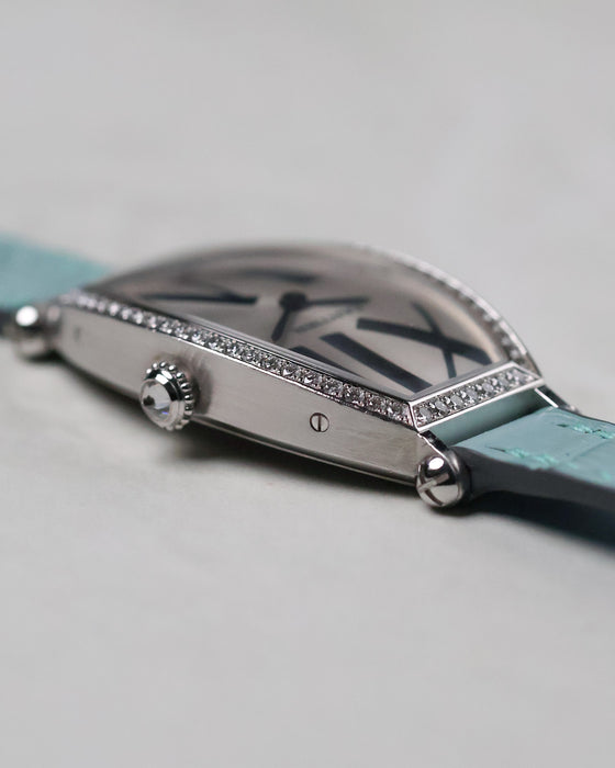 Side angle of the Cartier Tonneau WE400731 with focus on the faceted crown and diamond-set bezel.