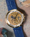 Front view of the Chaumet Pebble 13A skeleton dial with blue Roman chapter ring and blue leather strap.