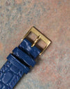 Original Chaumet 18k yellow gold pin buckle attached to the blue leather strap.