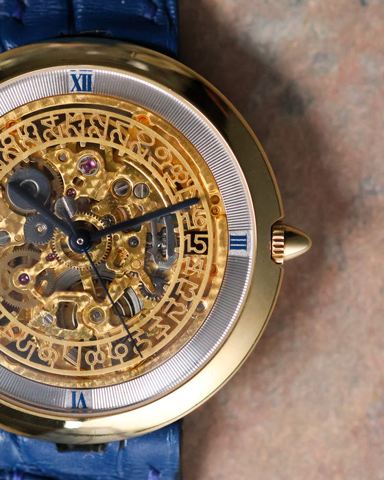 Macro detail of the Chaumet Pebble 13A skeletonised date wheel and blue Roman numeral chapter ring.