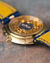 Side profile of the Chaumet Pebble 13A showing the polished 18k yellow gold case and open case back.