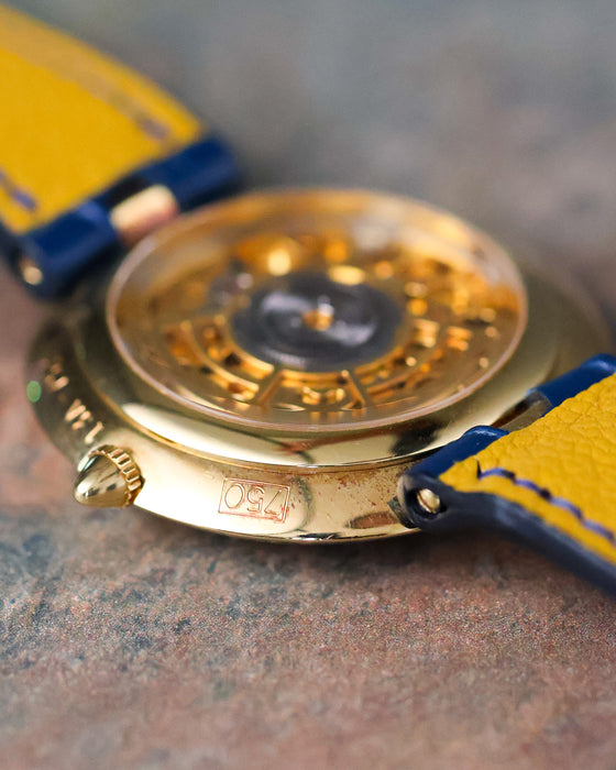 Side profile of the Chaumet Pebble 13A showing the polished 18k yellow gold case and open case back.