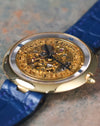 Three-quarter view of the Chaumet Pebble 13A with polished 18k yellow gold case and skeleton dial.