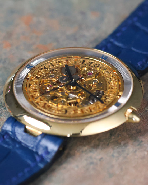 Three-quarter view of the Chaumet Pebble 13A with polished 18k yellow gold case and skeleton dial.