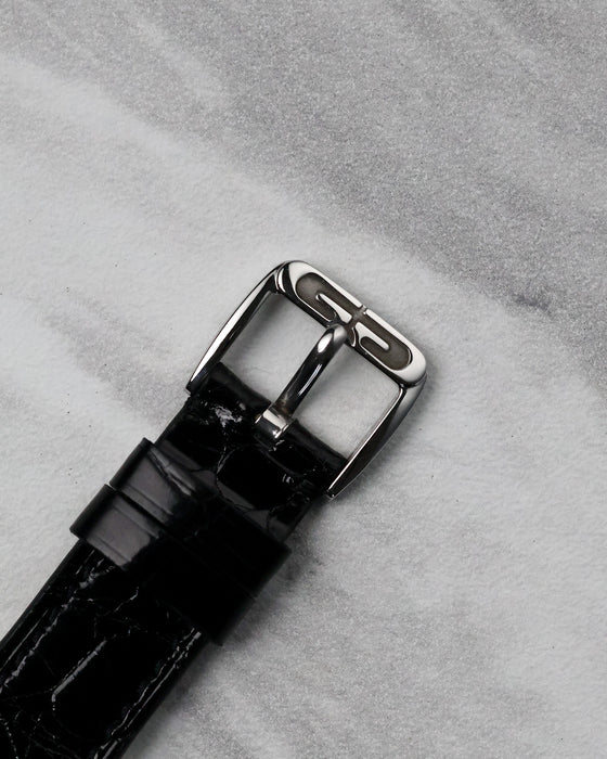 Original steel Gerald Genta buckle attached to the black leather strap of the G.3614.