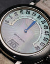 Macro detail of the Gerald Genta G.3614 mother of pearl dial with retrograde minute scale and jumping hour display.