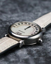 Low angled profile view of the Gerald Genta Retro Classic G.3614 showing the fluted steel caseband and retrograde display.

