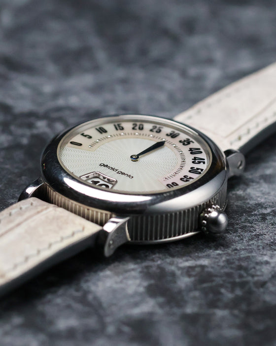 Low angled profile view of the Gerald Genta Retro Classic G.3614 showing the fluted steel caseband and retrograde display.


