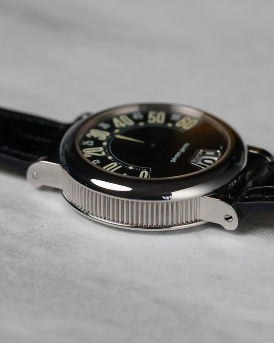 Low angled view of the Gerald Genta Retro Classic G.3614 black dial with retrograde display and polished steel case.